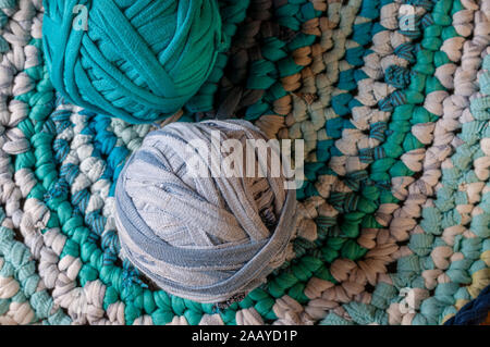 pink rag rug with balls of  tshirt wool.,cosy weekend. Stock Photo