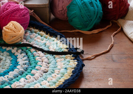 pink rag rug with balls of  tshirt wool.,cosy weekend. Stock Photo