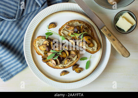 Food photography of toasted ciabatta bread crostini with mushroom paté /pate with sautéed mushrooms. Stock Photo