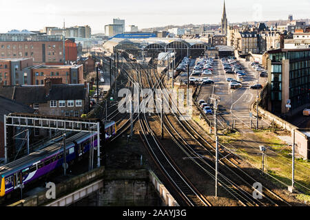 Wide angle view of grand old Newcastle Central railway and multiple tracks and points as a train is leaving the station Stock Photo