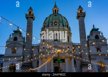 art christmas advent market in Vienna at the Karsplatz with cathedral and light garland Stock Photo