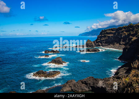 Swimming natural pools of volcanic lava in Seixal, Madeira island, Portugal, Europe. There is beautiful view on sea cliffs and waves of Atlantic ocean