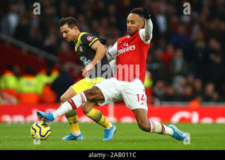 LONDON, United Kingdom, NOVEMBER 23. Arsenal's forward Pierre-Emerick Aubameyang and Southampton's defender Cedric Soares compete for the ball during Stock Photo