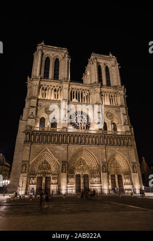 A west facade of the Notre-Dame de Paris Cathedral illuminated in the night, Paris Stock Photo