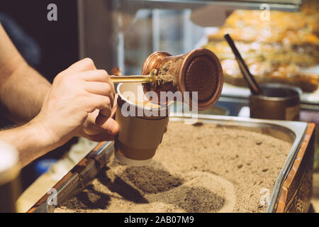 Brewing Turkish coffee on hot sand. The traditional method of making coffee in Turkey and the Middle East. Stock Photo