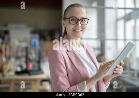 Successful businesswoman using digital tablet while preparing presentation Stock Photo