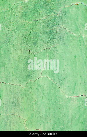 Grunge weathered cracked painted plastered wall closeup as green background Stock Photo