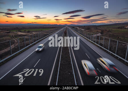 Driving on open road at beautiful sunny day to new year 2020. Aerial view Stock Photo