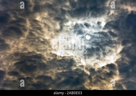 Dramatic sky with clouds backlit by the rays of the sun Stock Photo