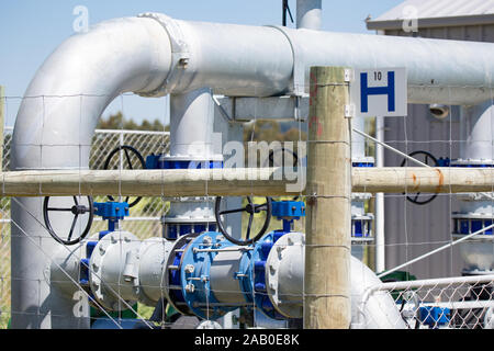 Up close photo of a fenced-off irrigation control system on a farm in New Zealand Stock Photo