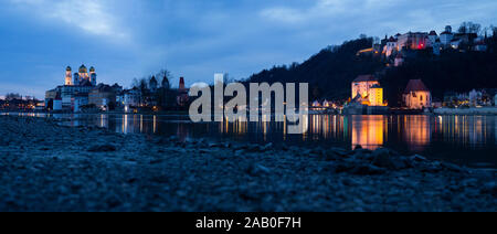 Panorama of Passau at the confluence of Ilz, Inn and Danube with view towards Oberhaus castle at dusk Stock Photo