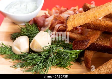 Beer croutons with garlic, sauce and herbs. Stock Photo