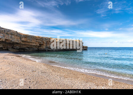 Beach of Spilies or Kitrenosi with sea caves near Rethimno, Crete, Greece. Stock Photo