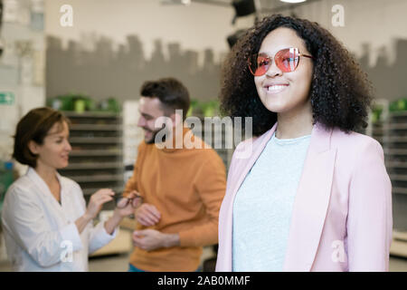Young cheerful woman with toothy smile wearing new eyeglasses Stock Photo