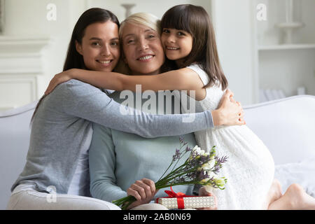 Three female generations celebrating International Womens Day looking at camera Stock Photo