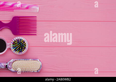 Colorful hair brushes on pink background. Stock Photo