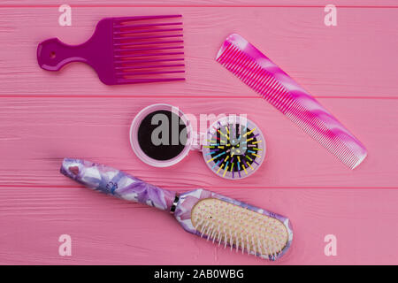 Hair combs and brushes on wooden background. Stock Photo