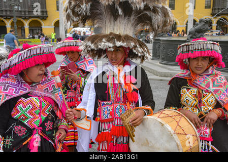 Lima, Peru - Nov 17, 2019: A group of musicians and dancers from Puno attend a procession in Lima's Plaza de Armas Stock Photo