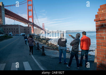 A group of people looks towards the Golden Gate Bridge in San Francisco. Stock Photo