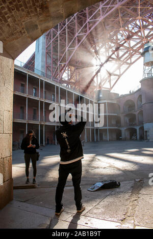 A man photographs an impressive scene at Fort Point in San Francisco. Stock Photo