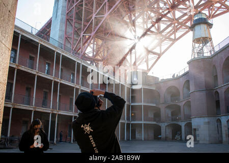 A man photographs an impressive scene at Fort Point in San Francisco. Stock Photo