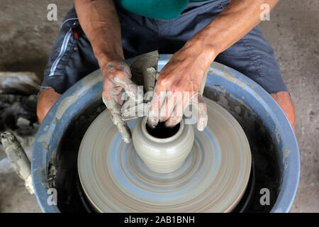 closeup of hands making pottery on pottery wheel Stock Photo