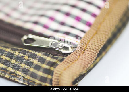 Metallic zipper for clothes / Close up open zip on handbag Stock Photo