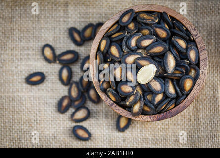 watermelon seeds in a wooden bowl / dried watermelon seed with salt for food or snack Stock Photo