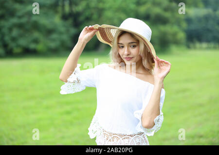 Pretty smiling joyfully female with fair hair, dressed casually, looking with satisfaction at camera, being happy. Outdoor shot of good-looking beauty Stock Photo