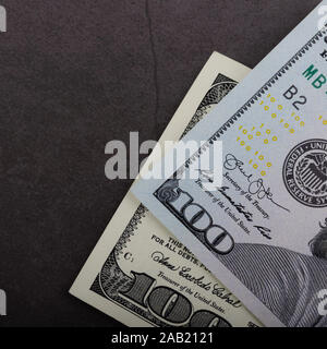 One hundred dollar bills on a gray background Stock Photo