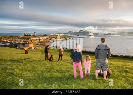 Roches Point, Cork, Ireland. 06th May,2018. A young couple with their children watch the departure in late evening light of the cruise ship MSC MERAVI Stock Photo