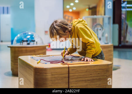 Boy in science class. The child is engaged in science Stock Photo