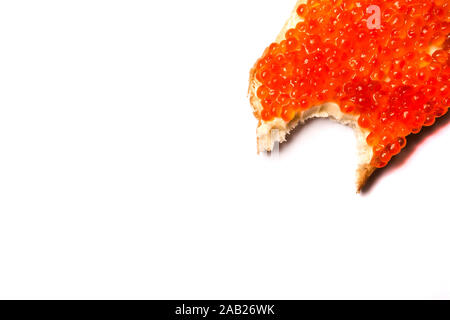 Bitten sandwich with butter and red caviar on a white background Stock Photo