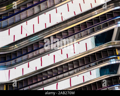 SINGAPORE – 20 MAR 2019 – Close up of escalators in the interior of Cuppage Plaza, Singapore. The escalators reflect the floor tiles to form a geometr Stock Photo