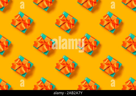 Pattern with stylish gift on a trendy orange background. Present for St. Valentine's day, engagements, Mother's Day, birthday, New Year, Christmas, holidays Stock Photo