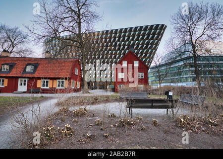 Traditional timber Falun red houses in front of the Aula Medica, Karolinska Institute (Karolinska Institutet), Solna, Stockholm, Sweden Stock Photo