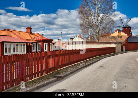 Falu red timber houses and windmill, Strangnas, Sodermanland County, Sweden Stock Photo