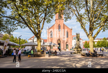 The Friedenskirche was built in 1817 on the Marktplatz, a large pedestrian square in Kehl, Germany, with sidewalk cafes and old plane trees. Stock Photo