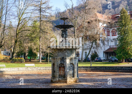 Beautiful sculpted water fountain with statue and art elements in the central park of Sinaia City , Romania Stock Photo