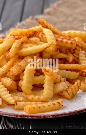 Fried crinkle cut french fries Stock Photo