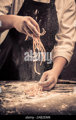 The chef makes fresh spaghetti from scratch. Stock Photo