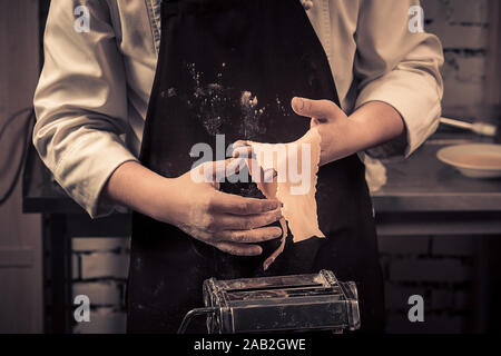 The chef makes fresh spaghetti from scratch. Stock Photo