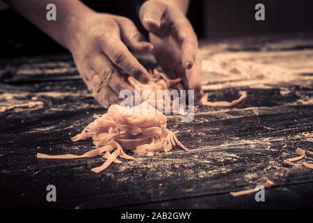 The chef makes fresh spaghetti from scratch. Stock Photo