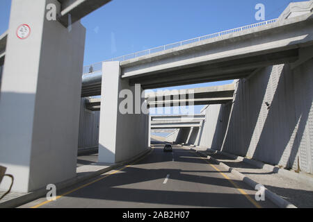 Concrete narrow underground tunnel for cars. Under the bridge is a pedestrian crossing.A small tunnel under the bridge on the road . road tunnel under Stock Photo