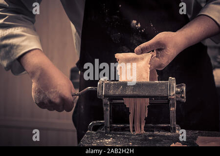 The chef makes fresh spaghetti from scratch. Stock Photo