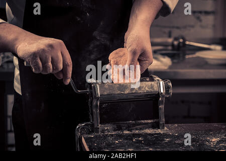 The chef makes fresh spaghetti from scratch. Stock Photo