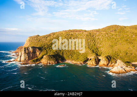 Knysna Heads. Looking from East Head to West Head with caves in Featherbed Nature Reserve Stock Photo