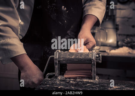 The chef makes fresh spaghetti from scratch. Stock Photo