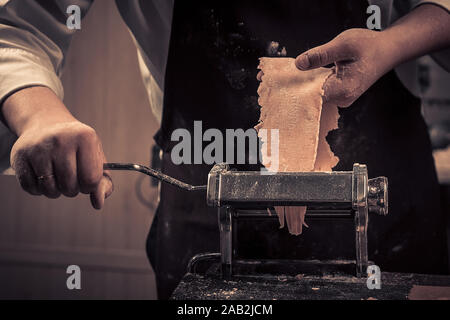The chef makes fresh spaghetti from scratch. Stock Photo