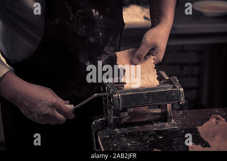 The chef makes fresh spaghetti from scratch. Stock Photo